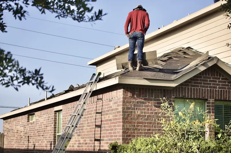 Professional roofer working on a residential roof in Huntington Terrace